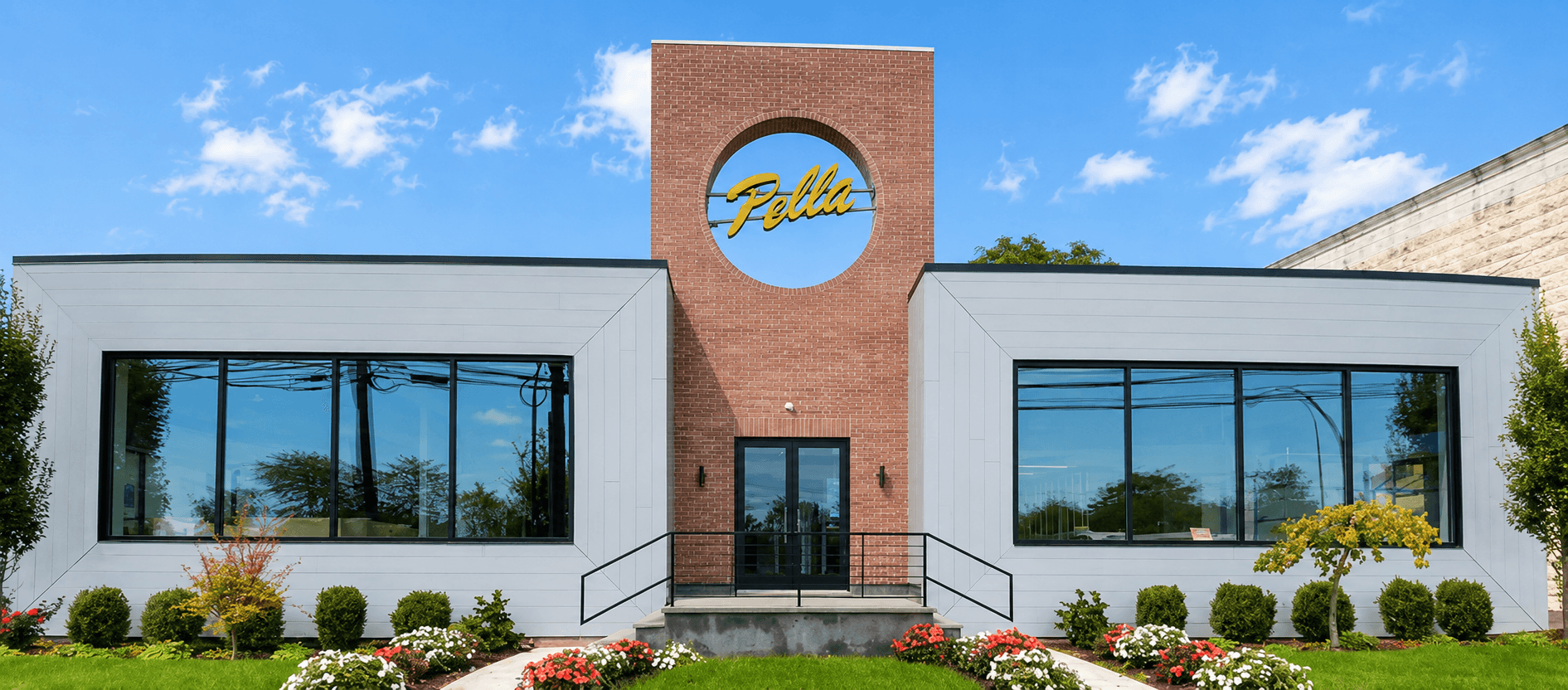 Pella showroom in Roslyn — brick tower with Pella logo flanked by white-clad wings